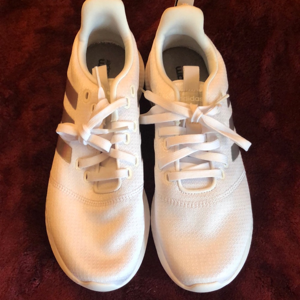 white adidas with silver stripes